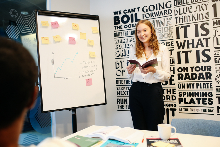 Student presenting on a whiteboard